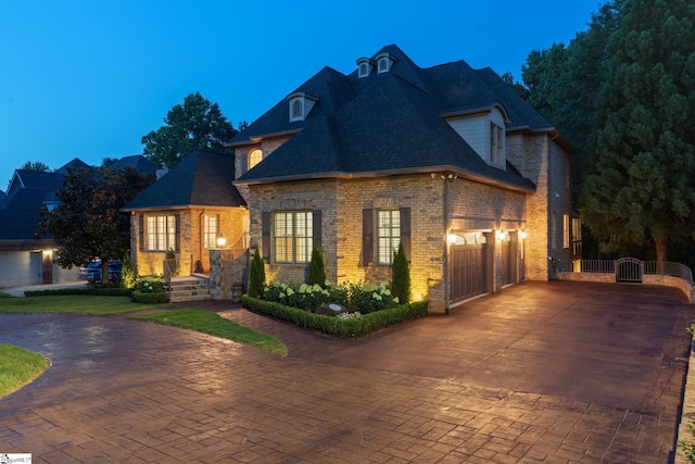 19 Hobcaw Dr, Greer, SC 29650 - french country inspired facade with brick siding, decorative driveway, a garage, a gate, and roof with shingles