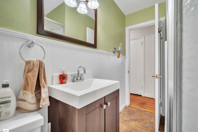 19 E Circle Ave, Greenville, SC 29607 - bathroom featuring a wainscoted wall, stone finish flooring, vanity, and a chandelier