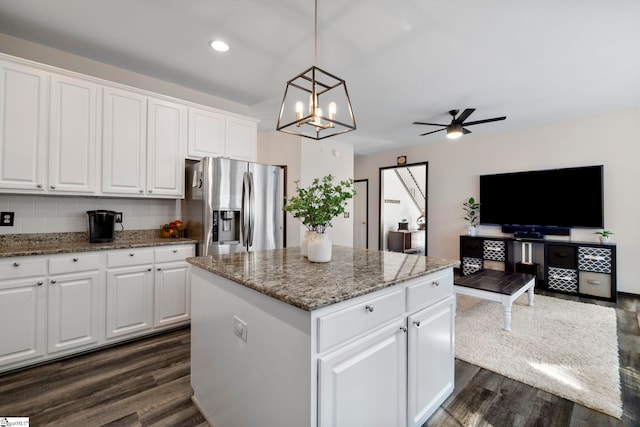 409 Summergreen Way, Greenville, SC 29607 - kitchen with stainless steel refrigerator with ice dispenser, a ceiling fan, a kitchen island, dark wood-style floors, and light stone counters
