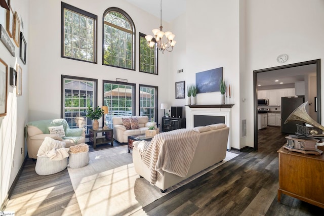 409 Summergreen Way, Greenville, SC 29607 - living room featuring dark wood-type flooring, a high ceiling, and a chandelier