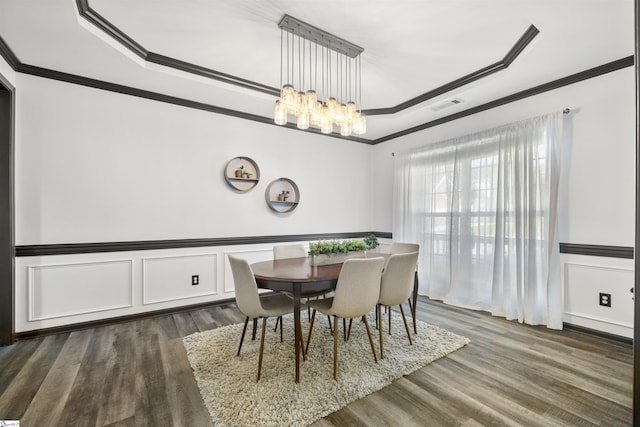 409 Summergreen Way, Greenville, SC 29607 - dining area with ornamental molding, a tray ceiling, a chandelier, dark wood-type flooring, and a decorative wall