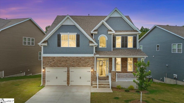 229 Layken Ln, Woodruff, SC 29388 - craftsman house featuring stone siding, a yard, covered porch, driveway, and an attached garage