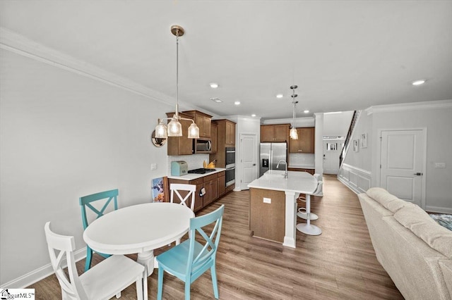 229 Layken Ln, Woodruff, SC 29388 - dining space featuring ornamental molding, wood finished floors, and recessed lighting