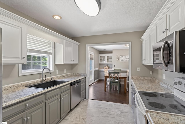 111 Falcon Ln, Chesnee, SC 29323 - kitchen with appliances with stainless steel finishes, light marble finish floors, white cabinets, light countertops, and a textured ceiling