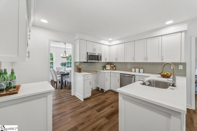 1117 Briarwood Dr, Easley, SC 29642 - kitchen featuring appliances with stainless steel finishes, dark wood finished floors, tasteful backsplash, white cabinetry, and recessed lighting