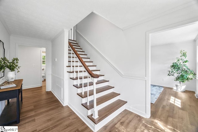 1117 Briarwood Dr, Easley, SC 29642 - staircase with wood finished floors and crown molding