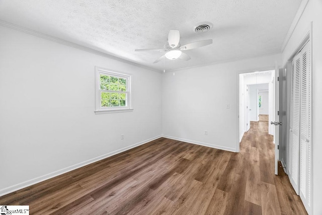 1117 Briarwood Dr, Easley, SC 29642 - unfurnished bedroom with a closet, ornamental molding, wood finished floors, a textured ceiling, and a ceiling fan