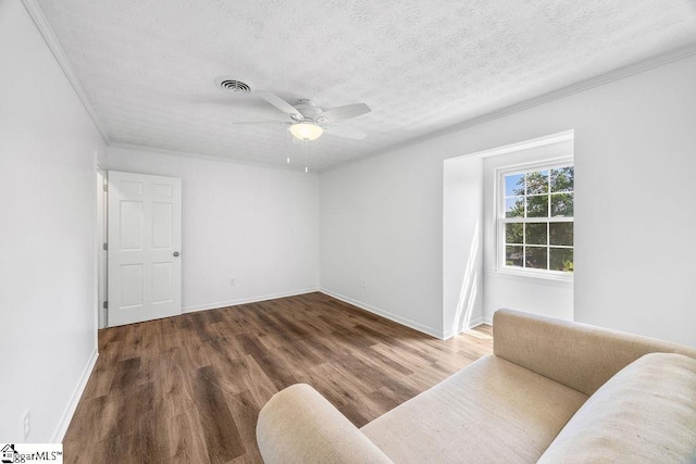 1117 Briarwood Dr, Easley, SC 29642 - unfurnished living room with a textured ceiling, ceiling fan, wood finished floors, and ornamental molding