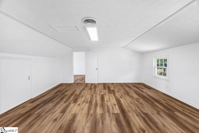 1117 Briarwood Dr, Easley, SC 29642 - bonus room with vaulted ceiling, wood finished floors, and a textured ceiling