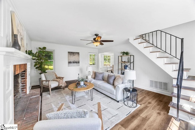 1117 Briarwood Dr, Easley, SC 29642 - living room featuring stairs, ceiling fan, wood finished floors, and a brick fireplace