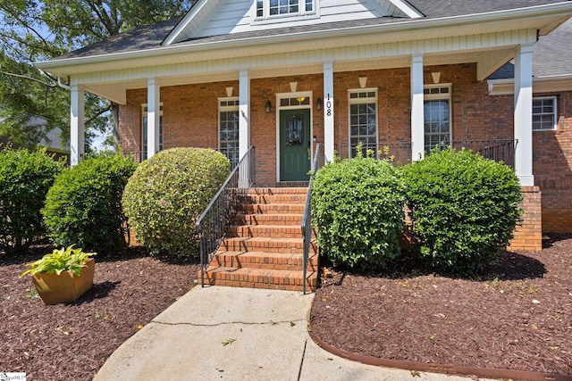 108 Goldenstar Ln, Greer, SC 29651 - view of exterior entry featuring brick siding, a porch, and a shingled roof