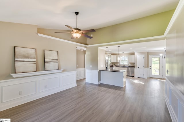 121 Stanmoore Dr, Anderson, SC 29621 - unfurnished living room with a decorative wall, crown molding, ceiling fan, light wood-style flooring, and a wainscoted wall