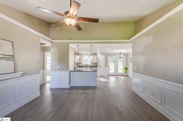 121 Stanmoore Dr, Anderson, SC 29621 - unfurnished living room featuring a decorative wall, wainscoting, a chandelier, a ceiling fan, and dark wood-style floors