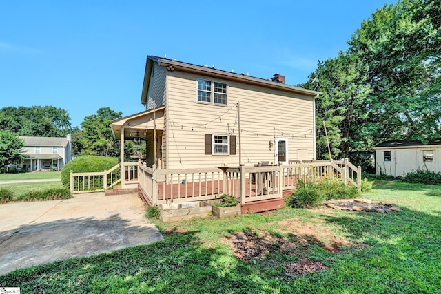 203 Camellia Ln, Simpsonville, SC 29681 - back of house featuring a yard, a chimney, and a storage shed