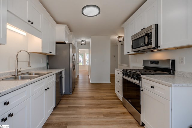 101 Clearbrook Ct, Greer, SC 29650 - kitchen featuring appliances with stainless steel finishes, white cabinets, light wood-type flooring, and light countertops