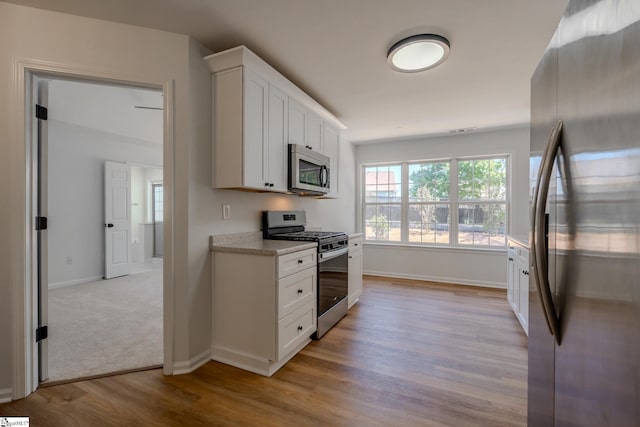 101 Clearbrook Ct, Greer, SC 29650 - kitchen with appliances with stainless steel finishes, light wood finished floors, and white cabinets
