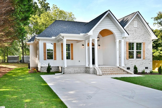 72 Seminole Dr, Simpsonville, SC 29680 - view of front of house featuring a porch, a front yard, a shingled roof, crawl space, and board and batten siding