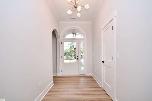 72 Seminole Dr, Simpsonville, SC 29680 - foyer with a chandelier, arched walkways, ornamental molding, and light wood finished floors
