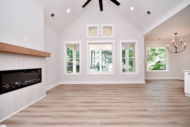 72 Seminole Dr, Simpsonville, SC 29680 - unfurnished living room with a glass covered fireplace, high vaulted ceiling, a chandelier, ceiling fan, and light wood-style floors