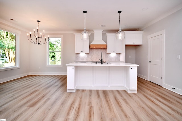 72 Seminole Dr, Simpsonville, SC 29680 - kitchen featuring custom range hood, light countertops, white cabinetry, a chandelier, and ornamental molding
