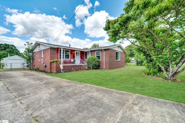 302 Douglas St, Laurens, SC 29360 - ranch-style home featuring brick siding, covered porch, a front lawn, and an outdoor structure