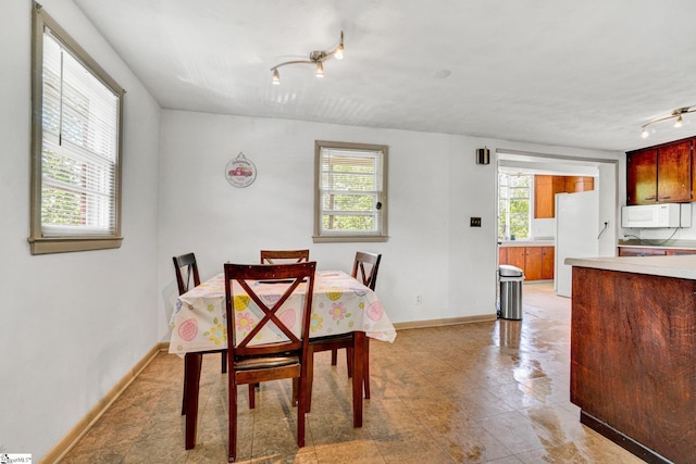 302 Douglas St, Laurens, SC 29360 - dining room with rail lighting and healthy amount of natural light