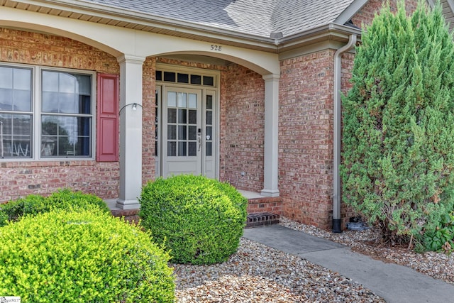 528 Carolee Way, Greer, SC 29651 - view of exterior entry featuring a shingled roof, brick siding, and a porch