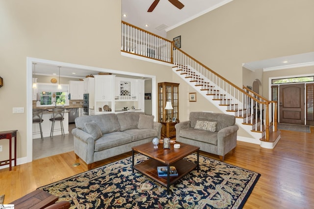 163 Tupelo Dr, Greer, SC 29651 - living room with stairway, plenty of natural light, ceiling fan, a high ceiling, and light wood-style floors