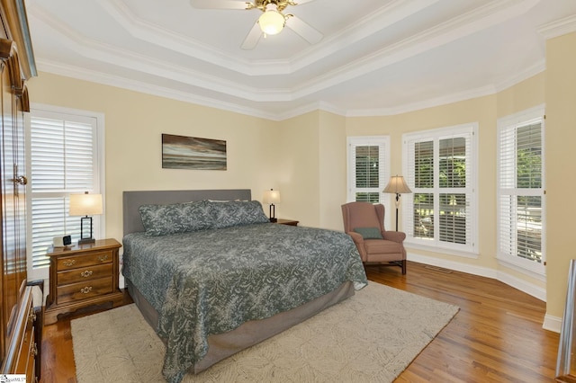 163 Tupelo Dr, Greer, SC 29651 - bedroom featuring a raised ceiling, wood finished floors, crown molding, and a ceiling fan