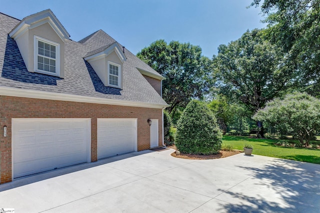 163 Tupelo Dr, Greer, SC 29651 - view of side of property featuring a shingled roof, driveway, brick siding, and a yard