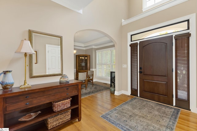 163 Tupelo Dr, Greer, SC 29651 - foyer entrance featuring arched walkways, light wood-style flooring, and crown molding