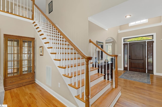 163 Tupelo Dr, Greer, SC 29651 - foyer featuring arched walkways, wood finished floors, and stairway