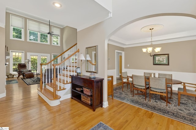 163 Tupelo Dr, Greer, SC 29651 - foyer entrance featuring arched walkways, light wood-style flooring, stairway, a chandelier, and ceiling fan