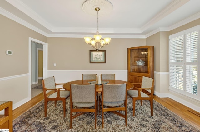 163 Tupelo Dr, Greer, SC 29651 - dining area with a chandelier, wood finished floors, and crown molding