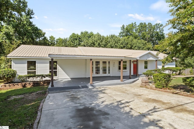 223 Speedway Dr, Fountain Inn, SC 29644 - view of front of property with french doors, driveway, a carport, and a metal roof