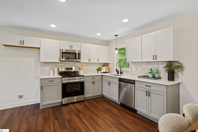 223 Speedway Dr, Fountain Inn, SC 29644 - kitchen featuring appliances with stainless steel finishes, dark wood-style floors, decorative backsplash, light countertops, and recessed lighting