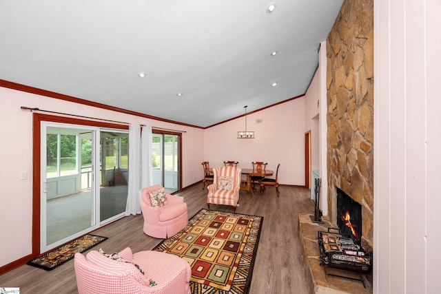 908 Harness Trl, Greenville, SC 29681 - living room featuring ornamental molding, vaulted ceiling, wood finished floors, a stone fireplace, and recessed lighting