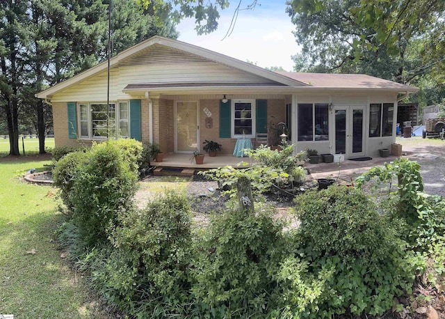 228 Styles Rd, Taylors, SC 29687 - ranch-style home with covered porch, a front yard, french doors, and brick siding