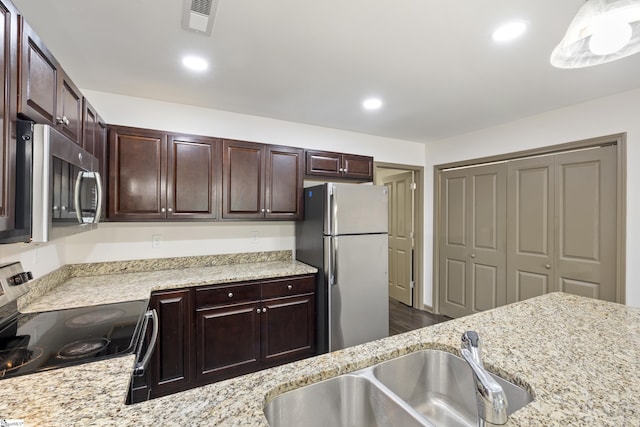 235B Pendleton Rd, Clemson, SC 29631 - kitchen with stainless steel appliances, dark brown cabinets, recessed lighting, and light stone countertops