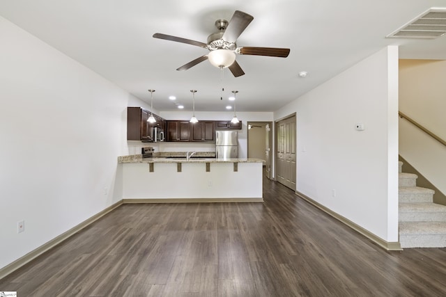 235B Pendleton Rd, Clemson, SC 29631 - kitchen with stainless steel appliances, a peninsula, dark wood-style floors, a ceiling fan, and dark brown cabinetry