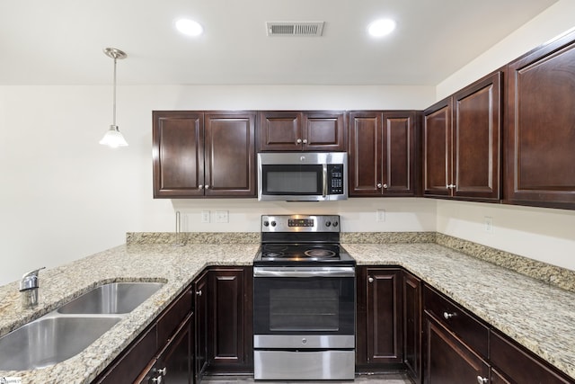 235B Pendleton Rd, Clemson, SC 29631 - kitchen featuring stainless steel appliances, decorative light fixtures, light stone counters, recessed lighting, and dark brown cabinetry