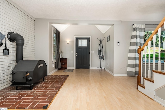 2 Line St, Taylors, SC 29687 - foyer with stairs, a wood stove, wood finished floors, and brick wall
