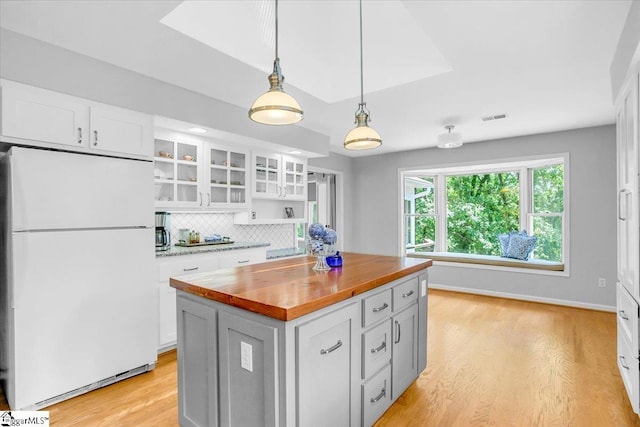 100 Whittlin Way, Taylors, SC 29687 - kitchen with freestanding refrigerator, wood counters, light wood-style flooring, and white cabinets