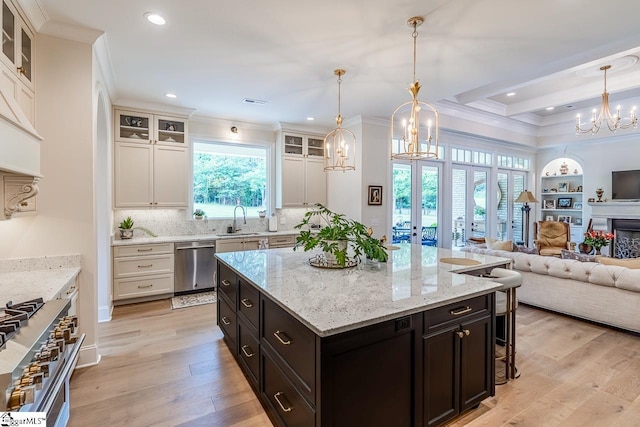 2765 Brockman Mcclimon Rd, Greer, SC 29651 - kitchen featuring stainless steel appliances, a chandelier, open floor plan, ornamental molding, and light wood-type flooring