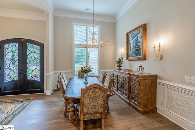 2765 Brockman Mcclimon Rd, Greer, SC 29651 - dining space with a chandelier, arched walkways, french doors, plenty of natural light, and a wainscoted wall