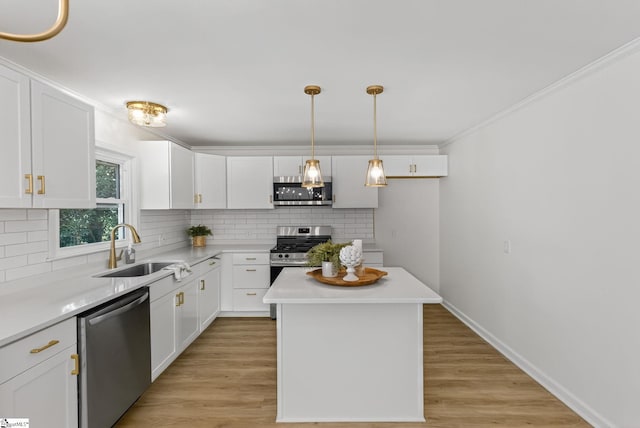 103 Gaithburg Sq, Taylors, SC 29687 - kitchen with appliances with stainless steel finishes, white cabinetry, tasteful backsplash, light countertops, and ornamental molding