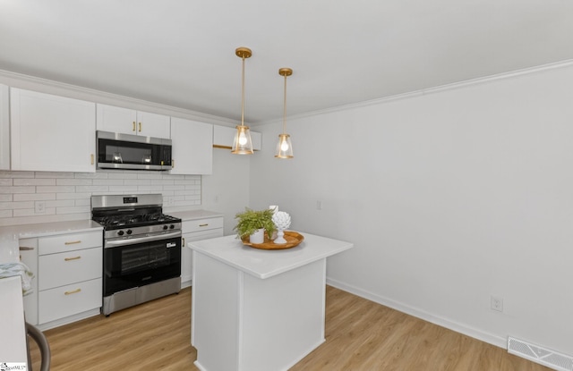 103 Gaithburg Sq, Taylors, SC 29687 - kitchen with appliances with stainless steel finishes, white cabinets, light countertops, decorative backsplash, and light wood-type flooring