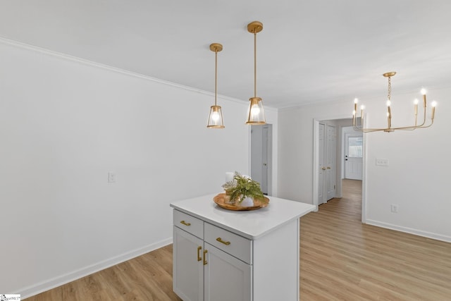 103 Gaithburg Sq, Taylors, SC 29687 - kitchen featuring a chandelier, light wood-style floors, crown molding, a center island, and light countertops