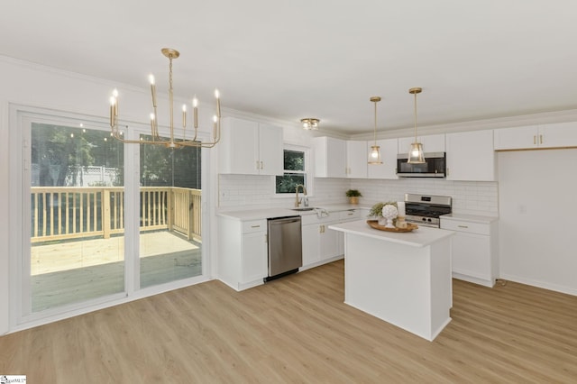 103 Gaithburg Sq, Taylors, SC 29687 - kitchen featuring stainless steel appliances, light countertops, decorative backsplash, white cabinets, and ornamental molding