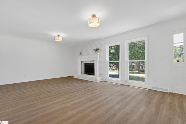 103 Gaithburg Sq, Taylors, SC 29687 - unfurnished living room featuring light wood-style flooring, ornamental molding, and a fireplace